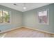 Bedroom featuring hardwood floors, a ceiling fan, and two bright windows at 4329 Spur St, North Charleston, SC 29405