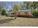 Charming single-story home features blooming azaleas, neutral siding, and a well-maintained lawn at 4329 Spur St, North Charleston, SC 29405