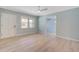 This is a living room showcasing a ceiling fan, light paint, wood flooring, and natural light at 4329 Spur St, North Charleston, SC 29405