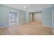 Bright living room with fresh paint, modern ceiling fan, and new light wood flooring at 4329 Spur St, North Charleston, SC 29405