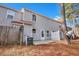 Rear exterior view showing gray siding, private patio, and tree-lined backyard at 517 Travelers Blvd, Summerville, SC 29485