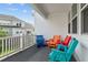 Private balcony with colorful chairs and white railings at 534 Mclernon Trace, Johns Island, SC 29455
