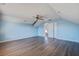 Large bedroom with light blue walls, ceiling fan, hardwood floors, and access to upper floor at 109 Red Leaf Blvd, Moncks Corner, SC 29461