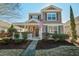 Two-story house with a front porch, landscaped yard, and American flag at 109 Red Leaf Blvd, Moncks Corner, SC 29461