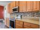 Kitchen boasts stainless steel appliances and wood cabinets at 109 Red Leaf Blvd, Moncks Corner, SC 29461