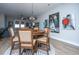 Round dining table with chairs in an open concept space with hardwood floors at 113 Claret Cup Way, Charleston, SC 29414