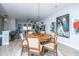 Bright dining area with wood table and chairs, hardwood floors, and modern art at 113 Claret Cup Way, Charleston, SC 29414