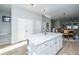 White quartz kitchen island with seating and a view into the living area at 113 Claret Cup Way, Charleston, SC 29414