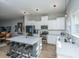 Modern kitchen with stainless steel appliances, white cabinets, and a large quartz island at 113 Claret Cup Way, Charleston, SC 29414