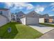 View of detached garage with driveway and grassy area at 117 Wonder Sol Way, Summerville, SC 29485