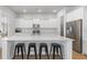 Modern kitchen with white cabinets, large island, and stainless steel appliances at 117 Wonder Sol Way, Summerville, SC 29485