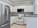 Modern kitchen with stainless steel appliances and granite countertops at 130 River Landing Dr # 7210, Daniel Island, SC 29492