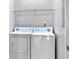 Laundry room with washer and dryer and overhead shelving at 130 River Landing Dr # 7210, Daniel Island, SC 29492