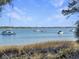 Calm water view with boats and marsh at 130 River Landing Dr # 7210, Daniel Island, SC 29492