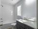 Modern bathroom with white subway tile, gray vanity, and a bathtub at 1421 Brownswood Rd, Johns Island, SC 29455