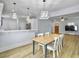Bright dining area with light wood table and chairs, open to kitchen at 1421 Brownswood Rd, Johns Island, SC 29455