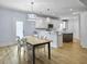 Dining area with a wood table and chairs, adjacent to the kitchen at 1421 Brownswood Rd, Johns Island, SC 29455