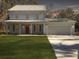 Two-story light blue house with a double garage and a manicured lawn at 1421 Brownswood Rd, Johns Island, SC 29455