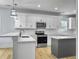 Modern kitchen with white cabinets, marble countertops, and island at 1421 Brownswood Rd, Johns Island, SC 29455