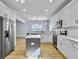 Modern kitchen with white cabinets, large island, and stainless steel appliances at 1421 Brownswood Rd, Johns Island, SC 29455