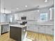Modern kitchen with white cabinets, a large island, and stainless steel appliances at 1421 Brownswood Rd, Johns Island, SC 29455