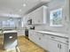 Modern kitchen with white cabinets, marble countertops, and stainless steel appliances at 1421 Brownswood Rd, Johns Island, SC 29455