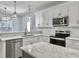Modern kitchen with white cabinets, marble countertops, and stainless steel appliances at 1421 Brownswood Rd, Johns Island, SC 29455