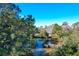 Aerial view of waterfront property with dock and tranquil pond setting at 1563 Headquarters Plantation Dr, Johns Island, SC 29455