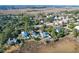 Aerial view of a waterfront community showcasing elegant homes nestled amongst trees at 1563 Headquarters Plantation Dr, Johns Island, SC 29455
