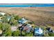 Aerial view of waterfront homes showcasing unique architectural styles and lush landscaping at 1563 Headquarters Plantation Dr, Johns Island, SC 29455
