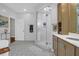 Spa-like bathroom with walk-in shower, patterned tile floor, and dual vanities at 1563 Headquarters Plantation Dr, Johns Island, SC 29455
