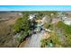 Gated entrance to a waterfront community with lush landscaping and palm trees at 1563 Headquarters Plantation Dr, Johns Island, SC 29455