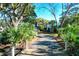 Wooden bridge leads to home; palm trees and lush landscaping at 1563 Headquarters Plantation Dr, Johns Island, SC 29455