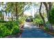 Arched bridge and lush landscaping line driveway leading to house at 1563 Headquarters Plantation Dr, Johns Island, SC 29455