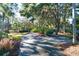 Long driveway leading to home through lush landscaping at 1563 Headquarters Plantation Dr, Johns Island, SC 29455