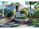 Two-story house with grand staircase, manicured landscaping, and brick accents at 1563 Headquarters Plantation Dr, Johns Island, SC 29455