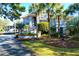 Two-story home with grand entrance, palm trees and lush landscaping at 1563 Headquarters Plantation Dr, Johns Island, SC 29455