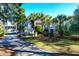 Two-story home with grand entrance, palm trees and lush landscaping at 1563 Headquarters Plantation Dr, Johns Island, SC 29455