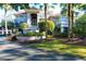 Two-story home with grand entrance, palm trees and lush landscaping at 1563 Headquarters Plantation Dr, Johns Island, SC 29455