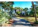 Two-story home with grand entrance, palm trees and lush landscaping at 1563 Headquarters Plantation Dr, Johns Island, SC 29455