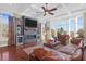 Spacious living room with fireplace, hardwood floors, and large windows at 1563 Headquarters Plantation Dr, Johns Island, SC 29455