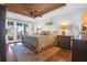 Spacious main bedroom with wood flooring, tray ceiling, and access to private balcony at 1563 Headquarters Plantation Dr, Johns Island, SC 29455