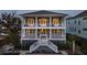 Two-story home with charming front porch and staircase, showcasing curb appeal at 1646 Red Tide Rd, Mount Pleasant, SC 29466