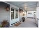 Front porch with light blue door, gray siding, and elegant lanterns at 1646 Red Tide Rd, Mount Pleasant, SC 29466