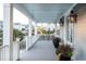 Spacious front porch with gray decking, white railings, and potted plants at 1646 Red Tide Rd, Mount Pleasant, SC 29466