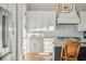 White kitchen with stainless steel appliances and hardwood floors at 1646 Red Tide Rd, Mount Pleasant, SC 29466