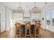 Modern kitchen featuring white cabinets, a blue island, and elegant lighting fixtures at 1646 Red Tide Rd, Mount Pleasant, SC 29466