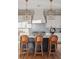 White kitchen with a statement range, custom range hood, and wicker barstools at 1646 Red Tide Rd, Mount Pleasant, SC 29466