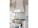 Stainless steel range with white custom hood and light gray backsplash at 1646 Red Tide Rd, Mount Pleasant, SC 29466