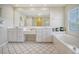 Double vanity bathroom with soaking tub and walk-in shower at 209 Charleston Blvd, Isle of Palms, SC 29451